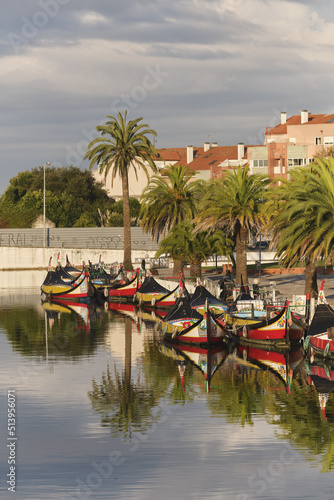 Traditional colorful boats called Moliceiros moored on the central canal in Aveiro, Portugal © hectorchristiaen