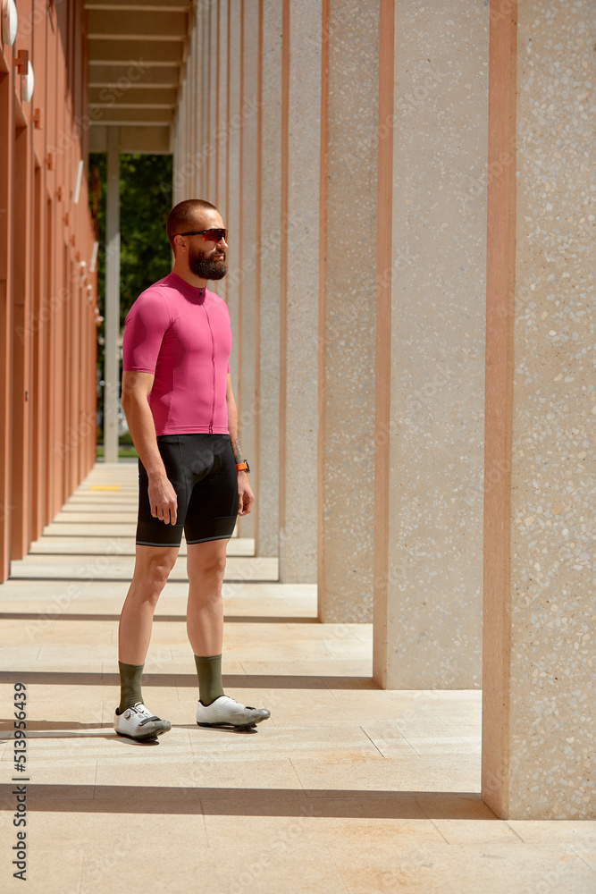 Portrait of a runner man take a rest after jogging while standing between columns copy space area for your text message information, sportsman taking a break