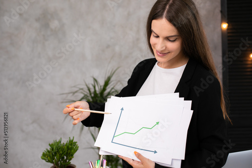 Happy woman smiling showing growth diagram, satisfied with financial and economic growth of his business
