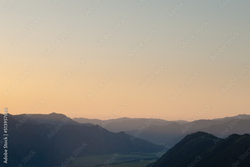 Beautiful gradient sunset sky over the mountains