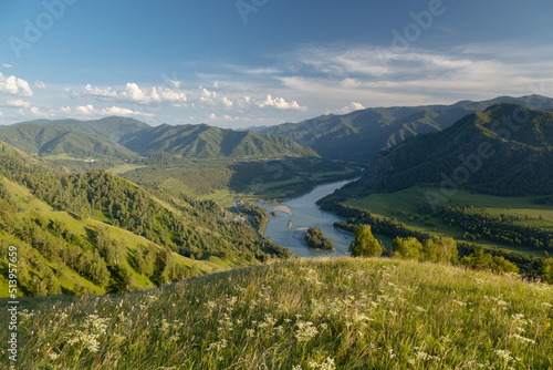 Beautiful mountain landscape with a river and a meadow