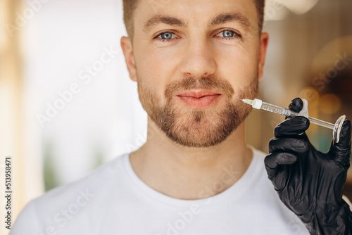 Man at beauty salon making injections