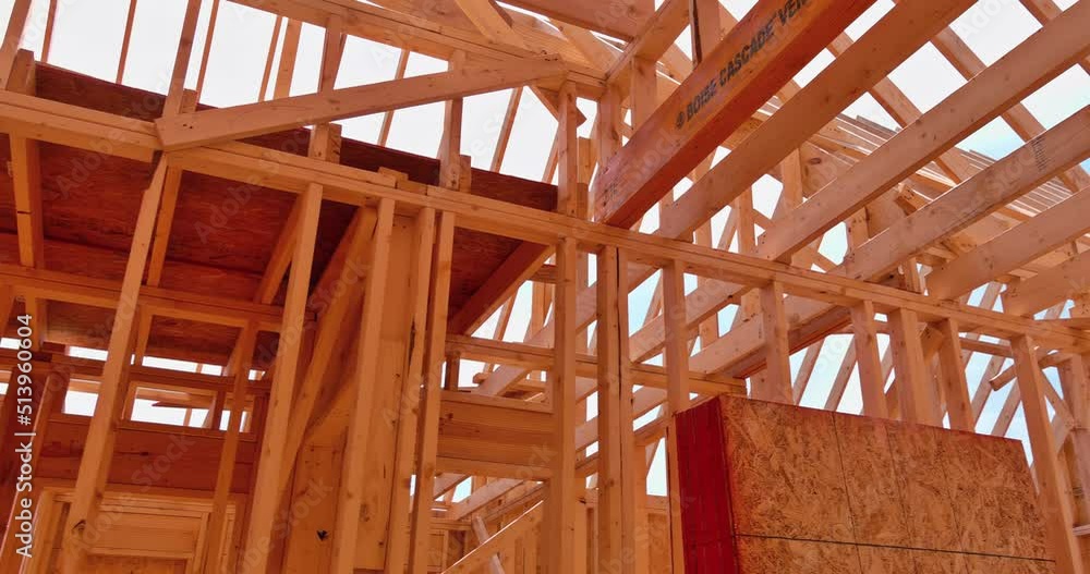 Wood framing beams stick framework of a built house under construction Wood framing beams stick framework of a built house under construction