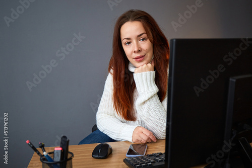 Woman with computer and smartphone work in office. Small business