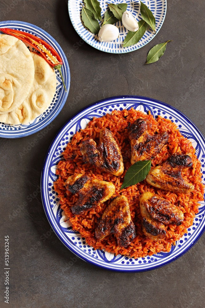 Jollof Rice. Traditional Nigerian spicy rice dish. National Jollof Rice day. Stock Photo Adobe