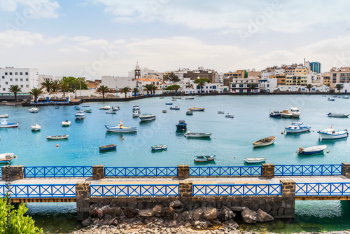 Arrecife quay with historic architecture and boats on blue water, Lanzarote, Canary Islands, Spain