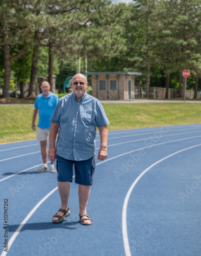 Two senior men on a walking track getting their daily exercise.