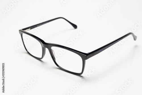 Carbon fiber degree glasses in black color. Side view and white background. Space for text.