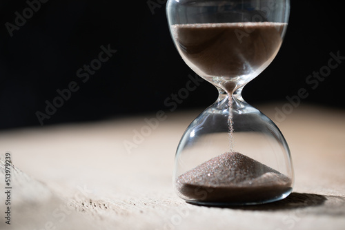 hourglass (sand clock) on the table, Hourglass as time passing concept for business deadline, elapsed time concept, copy space