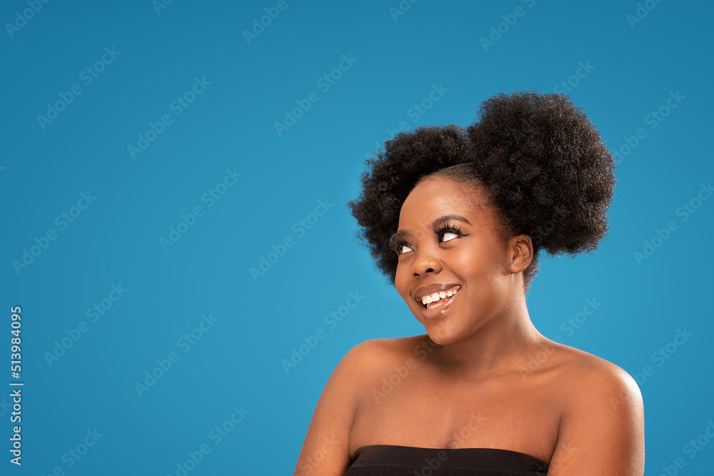 Smiling beauty afro young woman on blue studio background. Smiling beauty afro young woman on blue studio background.