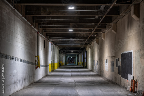 Dark empty illuminated back alley