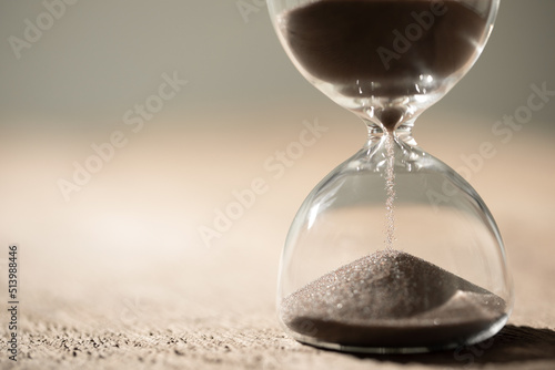 hourglass (sand clock) on the table, Hourglass as time passing concept for business deadline, copy space