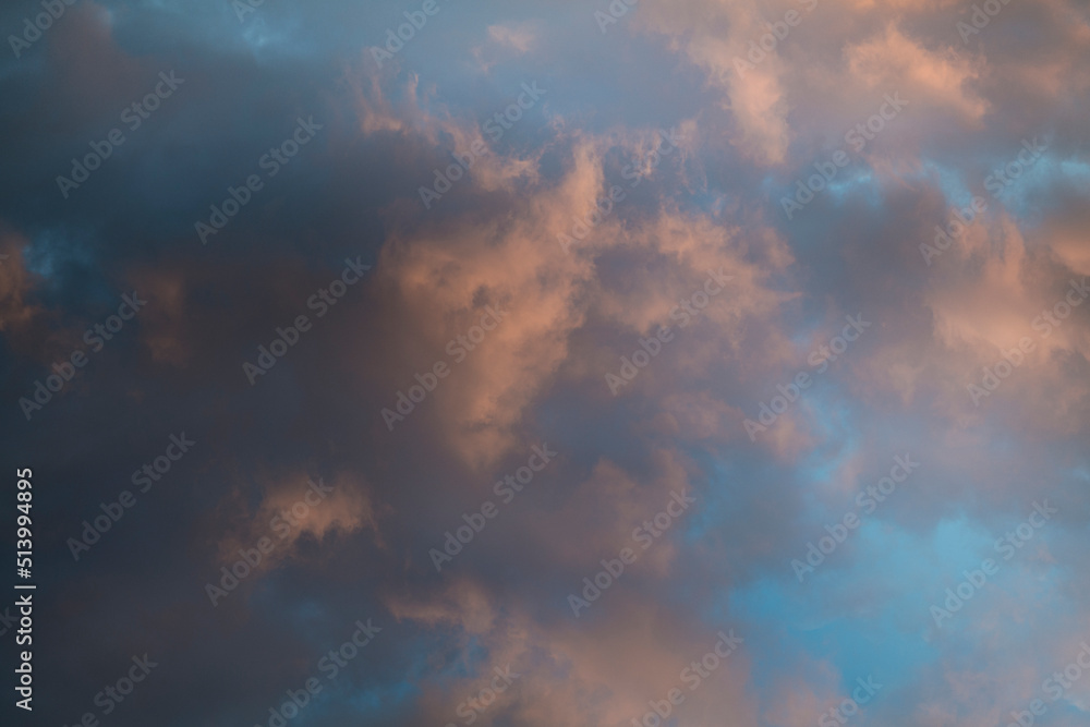 Beautiful evening sky with multi-colored bright clouds. Rain clouds at sunset. High-quality photo