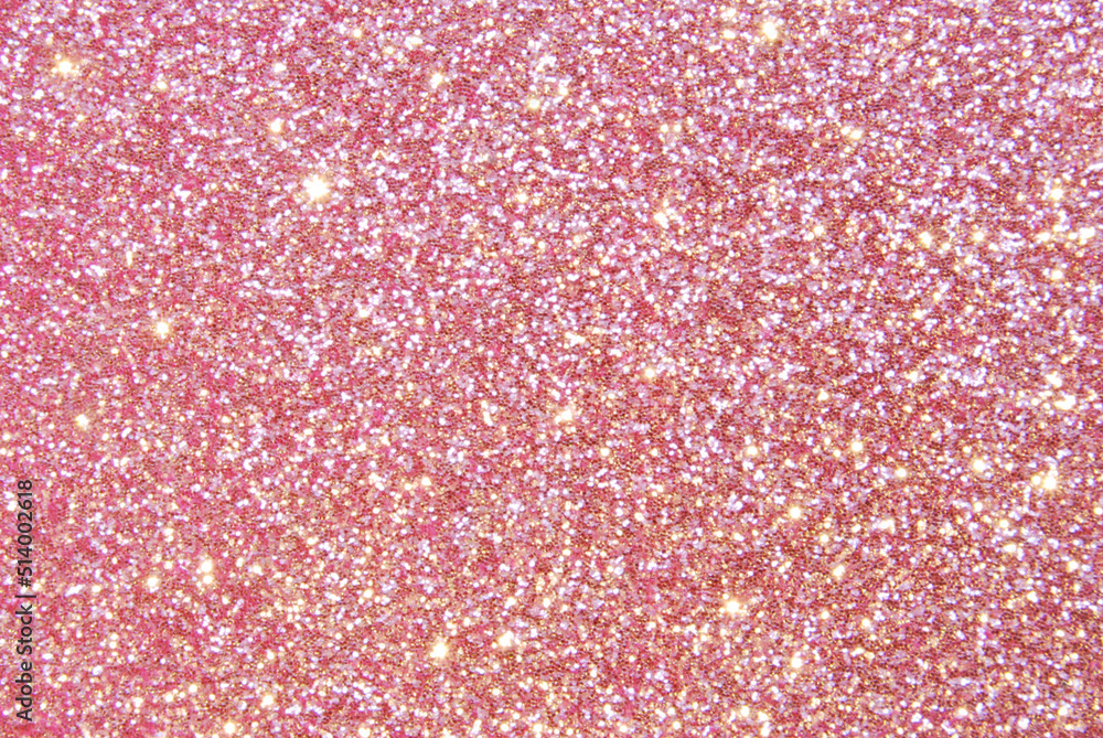 Pink de focused sparkle glitter background with golden particles