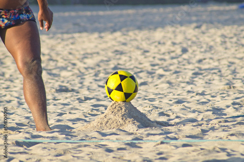 Boy playing footvolley on the beach