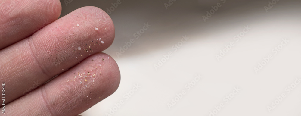 Micro plastic particles on a human finger for scale. Concept for water pollution and global warming. Macro shot on a bunch of microplastics that cannot be recycled Micro plastic particles on a human finger for scale. Concept for water pollution and global warming. Macro shot on a bunch of microplastics that cannot be recycled