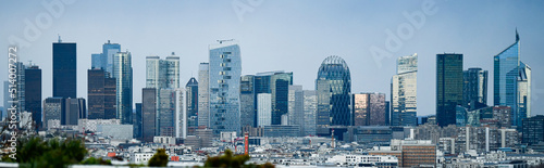 Panoramic view of the skyline of the financial district of La Défense, Paris, France (day time) with a blue sky in the background photo