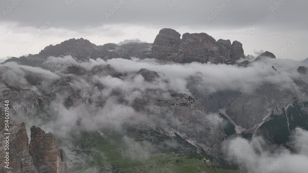 Beautiful cloudy day in Dolomites mountains. View on Tre Cime di Lavaredo - three famous mountain peaks that resemble chimneys. Beautiful cloudy day in Dolomites mountains. View on Tre Cime di Lavaredo - three famous mountain peaks that resemble chimneys.