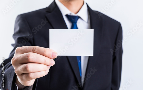 A hand holding a blank business card