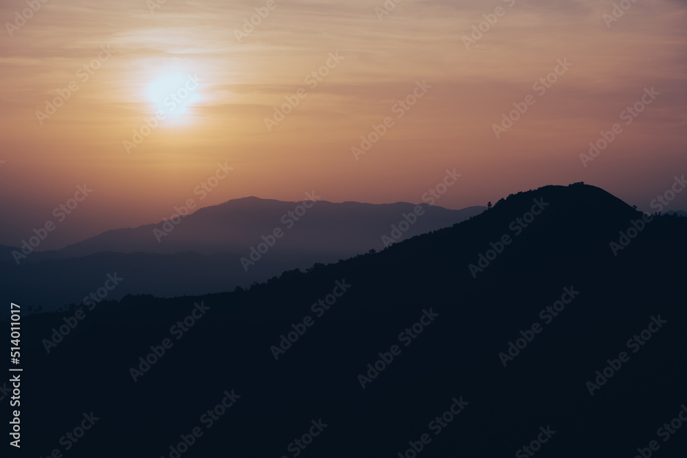 wide view  layer of mountain with sunrise background