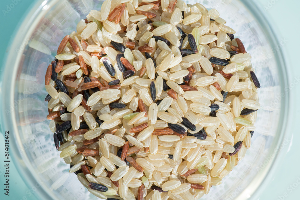 A mixture of wild rice grains: yellow, brown and black in a glass bowl. Plov preparation. A mixture of wild rice grains: yellow, brown and black in a glass bowl. Plov preparation.