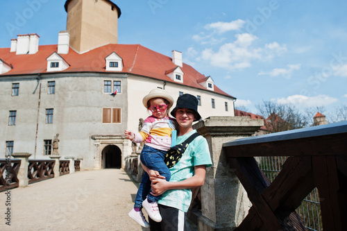 Brother with little sister in hands at Veveri castle, Czech Republic.