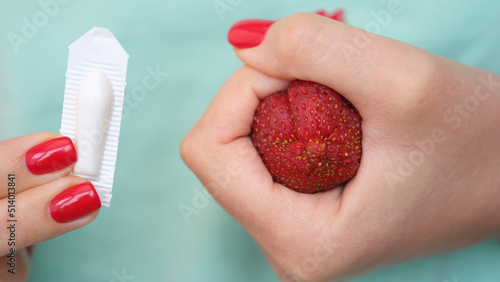 Photos Woman hand holds medical candles for constipation and anatomy of anus