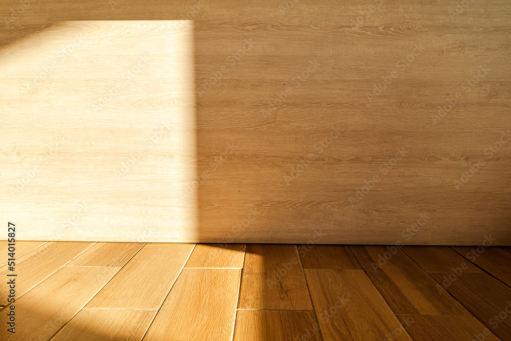 The sun shines on the corners of the wood wall and floor The sun shines on the corners of the wood wall and floor