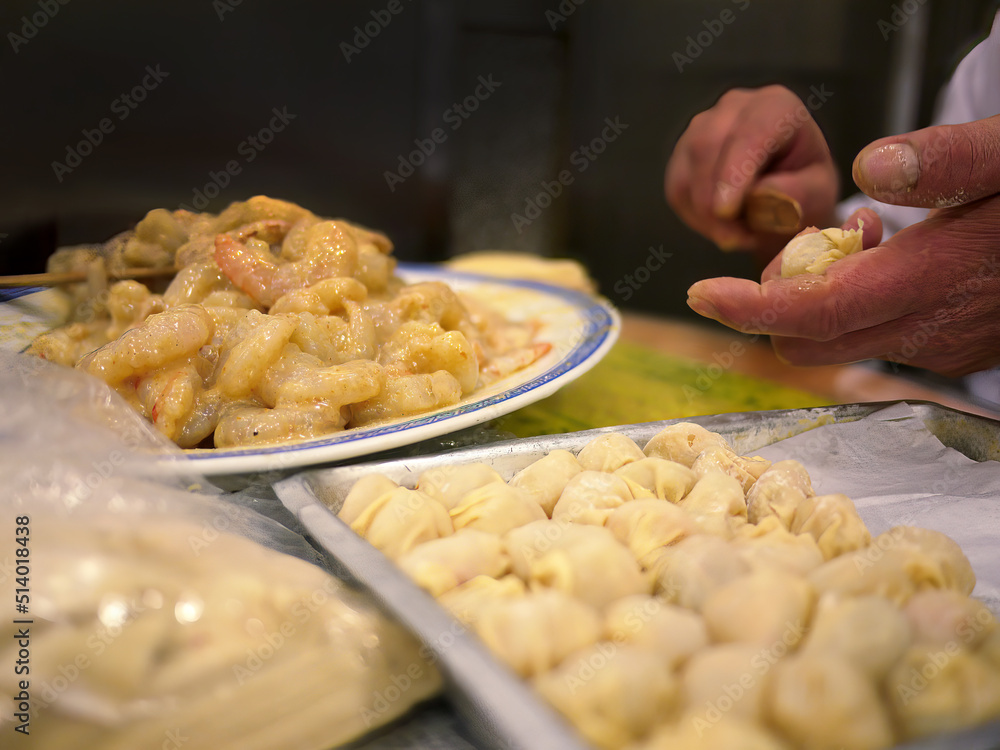 Close up local chef hand making raw shrimp wontons, dumpling, traditional style, famous local hong kong chinese cantonese food, selective focus Close up local chef hand making raw shrimp wontons, dumpling, traditional style, famous local hong kong chinese cantonese food, selective focus