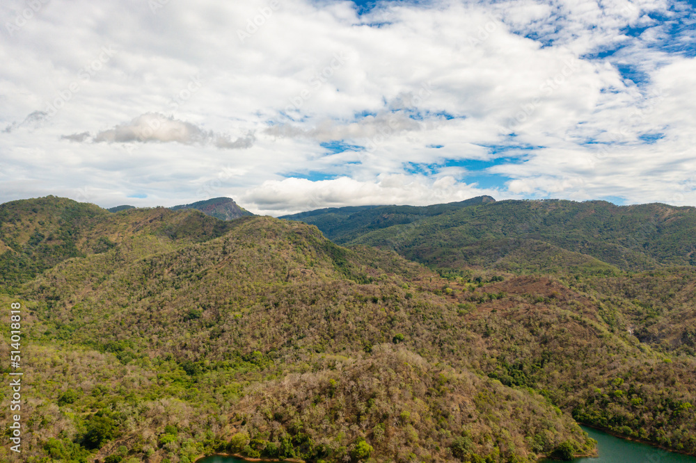 Aerial view of road on the slopes of mountains among tropical vegetation. Sri Lanka.