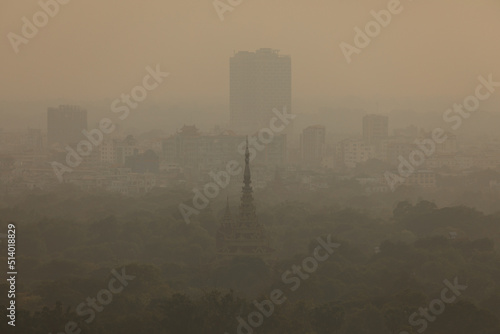 The city of Mandalay, submerged in the haze, polluted air and suspended dust of the afternoon, seen from above, on Mandalay Hill