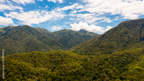 Aerial drone of Mountains covered rainforest, trees and blue sky with clouds. Sri Lanka. © Alex Traveler