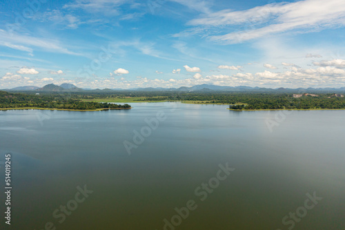 Aerial view of Sorabora lake in a mountain valley among the hills. Sri Lanka.