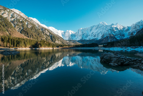 Beautiful reflection of the mountains in the lake. Lago di Fusine in winter time on the border of Slovenia and Italy.