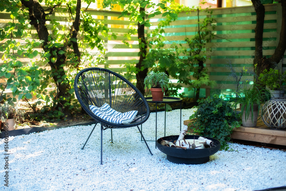 Outdoor patio furniture on pebbles in a front garden. Front veranda of