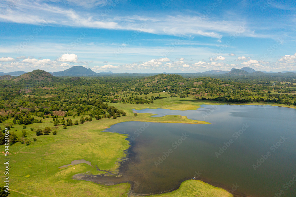 Beautiful Sorabora lake among hills with tropical vegetation. Sri Lanka.