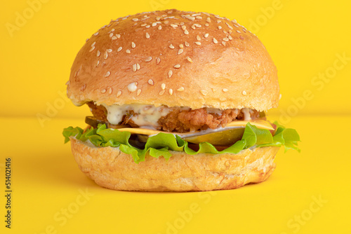 Burger with chicken, on a yellow background, bright background