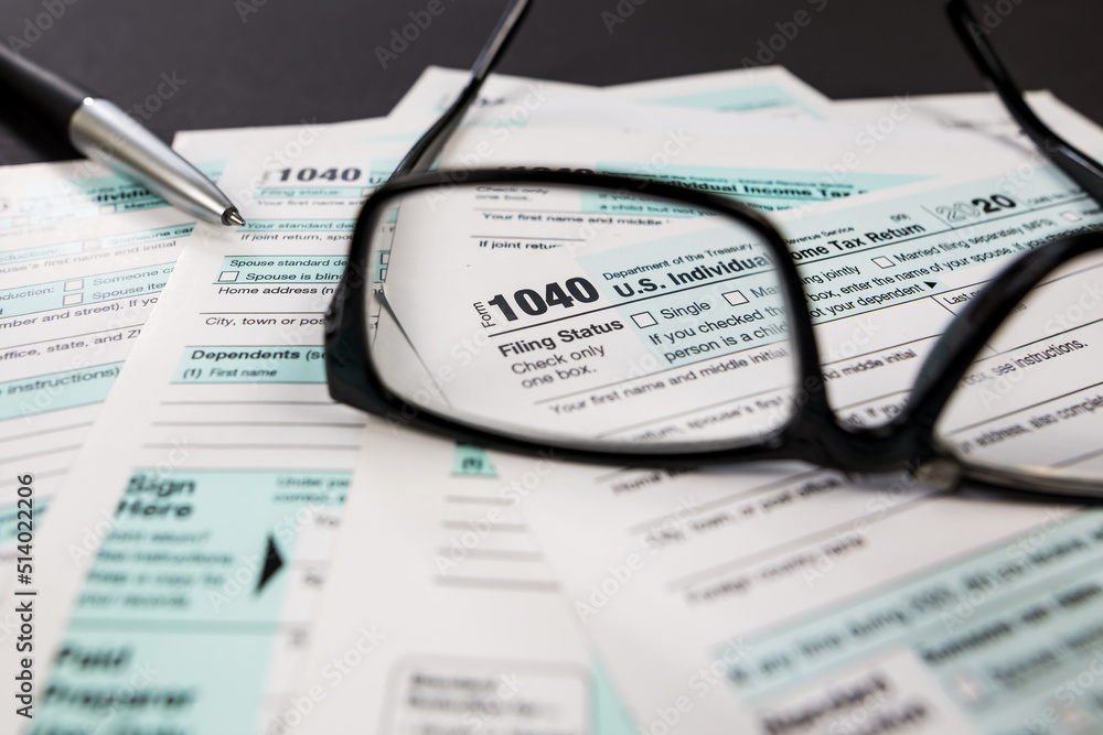 tax form 1040 is visible through glasses. tax form 1040 is visible through glasses.