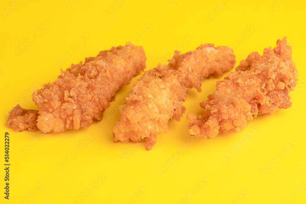 Chicken strips, chicken strips on yellow background, bright background Chicken strips, chicken strips on yellow background, bright background