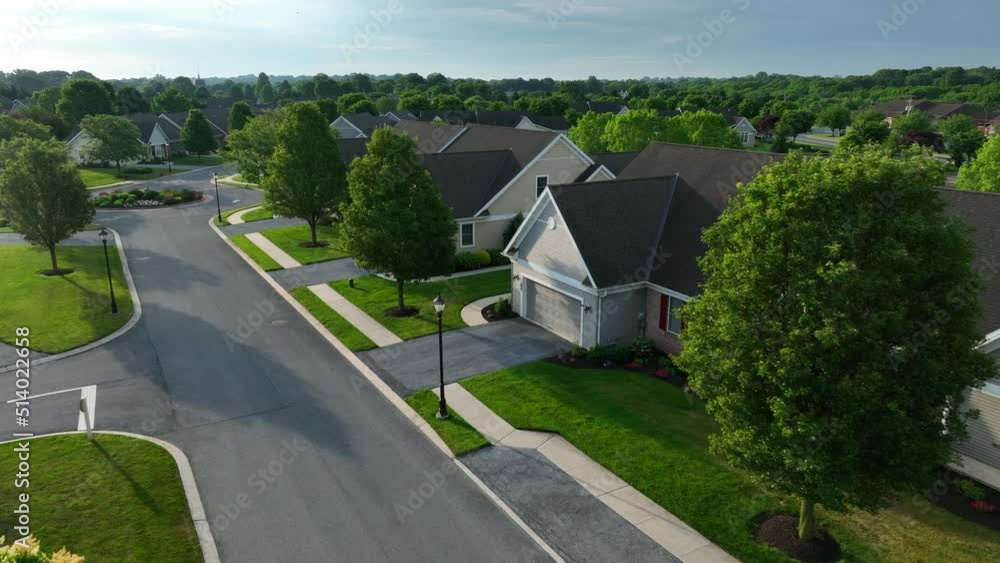 New single story homes in USA with mature trees along street. Senior 55 plus community houses. New single story homes in USA with mature trees along street. Senior 55 plus community houses.