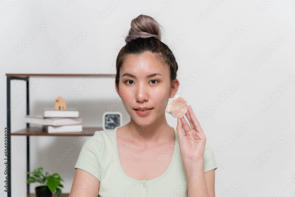 Asian women are using cotton pads moistened with cleansing wipes to remove make-up on their faces. Asian women are using cotton pads moistened with cleansing wipes to remove make-up on their faces.