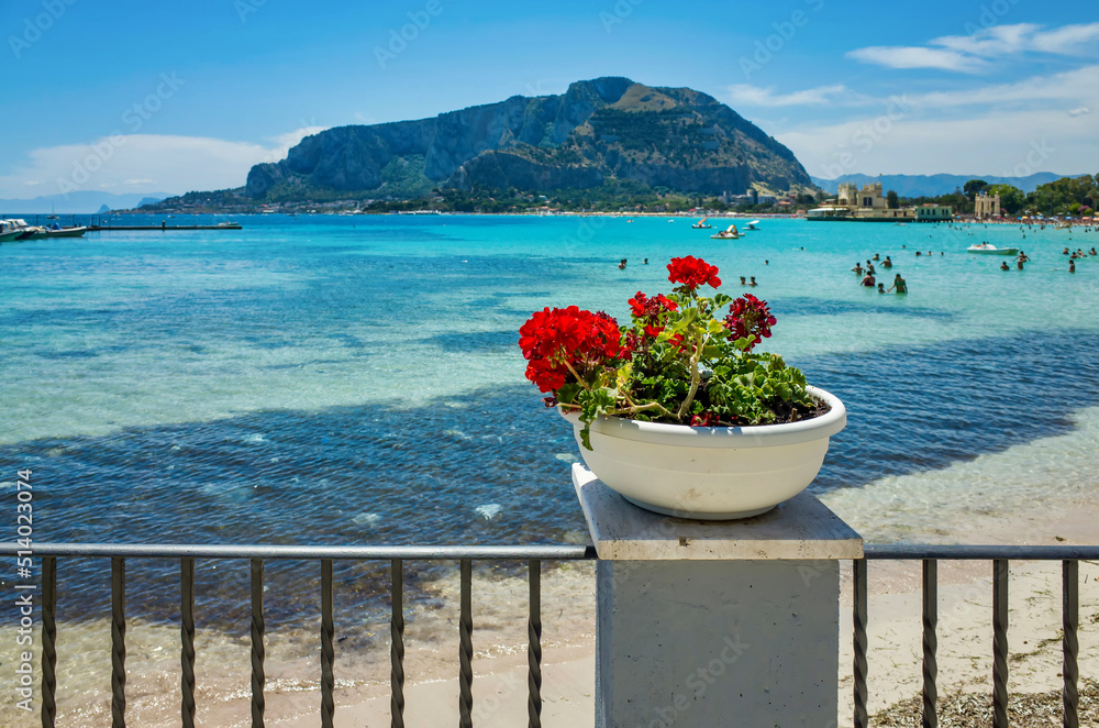 Palermo, Sicily - July 29, 2016: sea coast in Palermo. Beautiful old resort. Outdoor red flowers in a pot