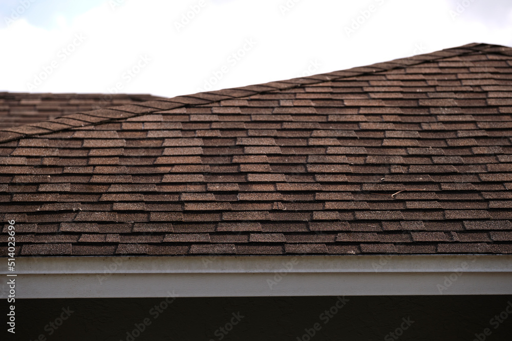 Closeup of house roof top covered with asphalt or bitumen shingles. Waterproofing of new building Closeup of house roof top covered with asphalt or bitumen shingles. Waterproofing of new building