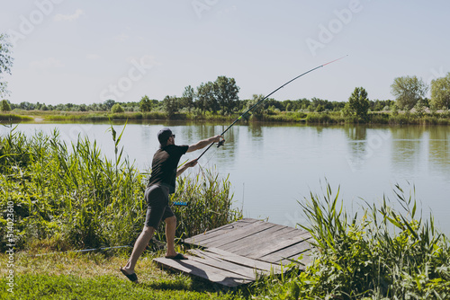 A man on a fishing trip casts a rod