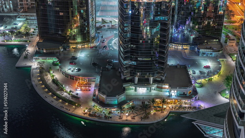 Tall residential buildings at JLT aerial night timelapse, part of the Dubai multi commodities centre mixed-use district.