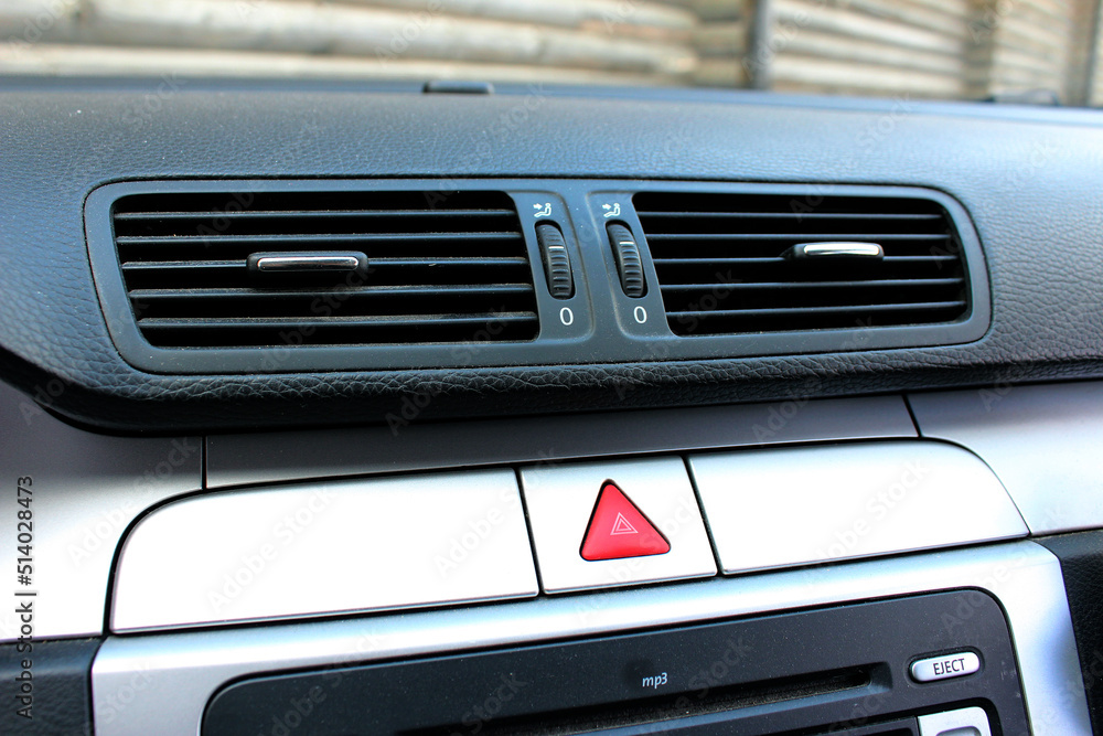 Car air vents close-up grille and hazard warning light swith in a
