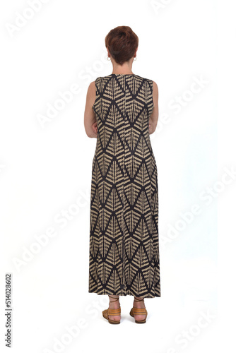 full back view of a middle aged woman wearing a dress, armd crossed on white background photo