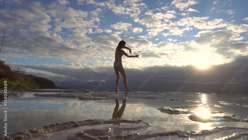 Aerial Drone Shot Asian Girl Dancing on the Edge of Natural Petrified Waterfall Hierve el Agua in Mexico, Oaxaca. 