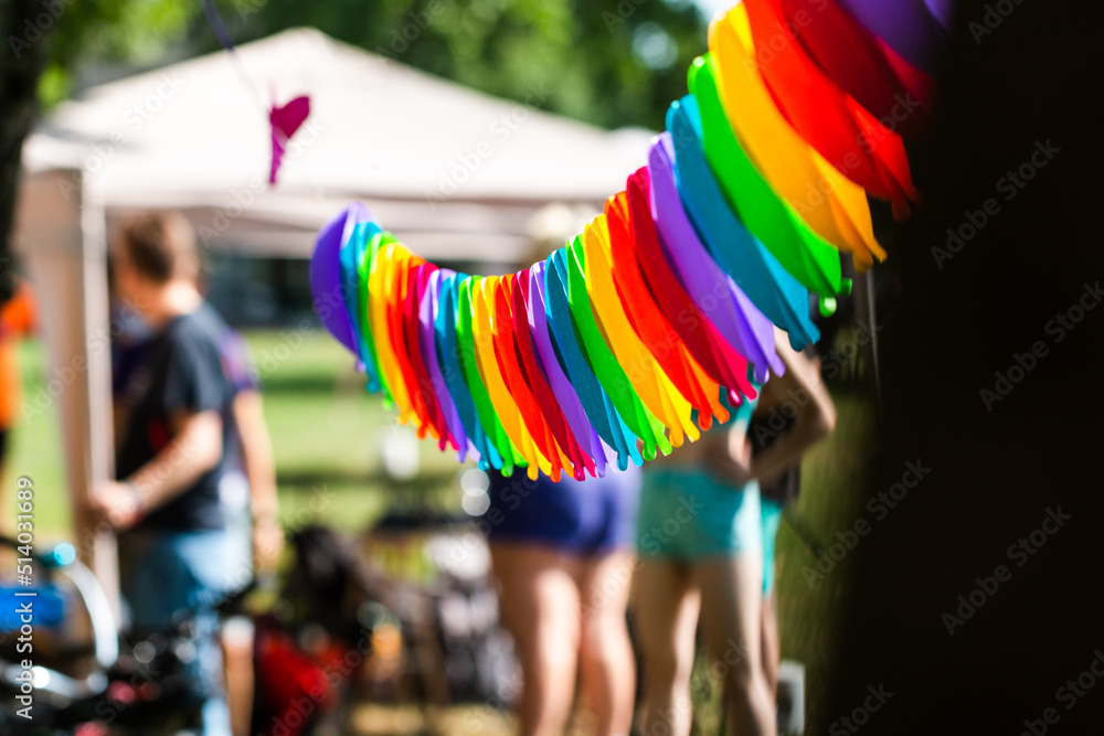 Obraz premium LGBTIQ+ rainbow color decoration at Pride event with out of focus people, members of LGBT community, in background
