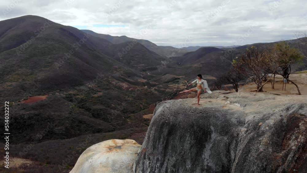 Aerial Drone Shot Asian Girl Dancing on the Edge of Natural Petrified Waterfall Hierve el Agua in Mexico, Oaxaca. 